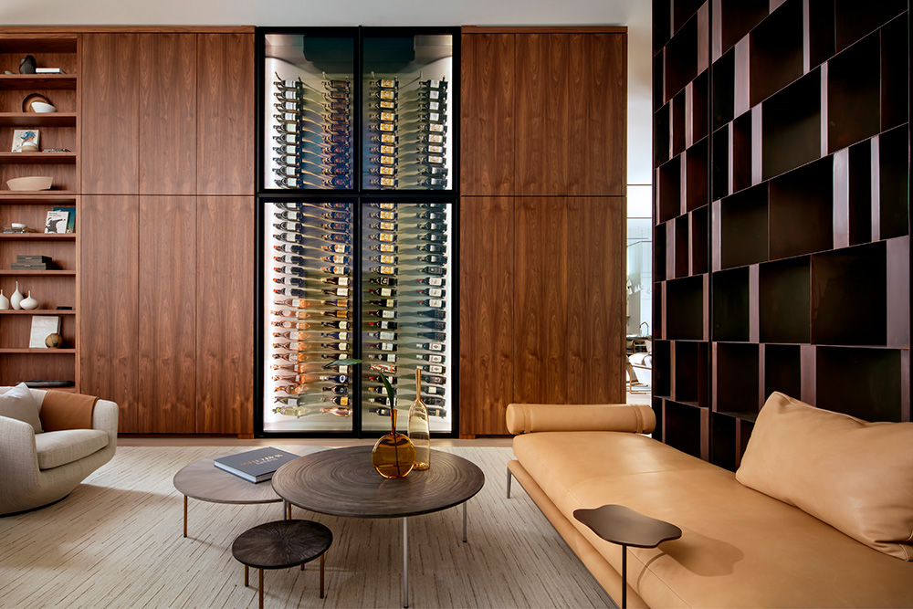 featured image of an elegant living room featuring a large custom-built glass wine cellar by the Wine Square and a stylish couch